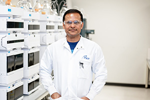Pace Life Sciences Scientist in front of Laboratory Equipment